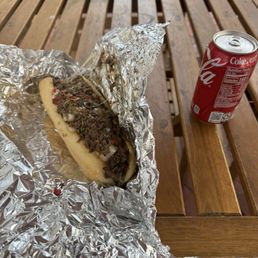 The small Philly Cheesesteak and a can of Coca-Cola.