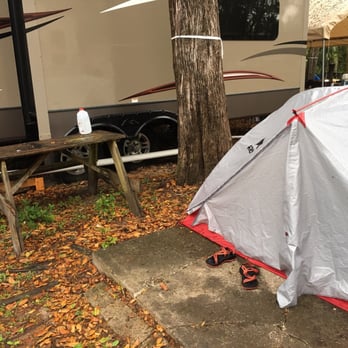 Nature's Resort - This is my tent, my picnic table with no seat that the neighbor had his stuff on, a busted up cement slab, and the next door neighbors RV. - RV Parks Near Me - Homosassa, Florida