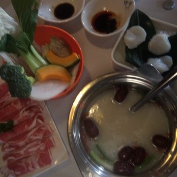Lao Pot - Broth is getting hot while my meats n veggies are waiting alongside of the pool and sauces to top it off - Hot Pot Near Me - Madison Heights, Michigan
