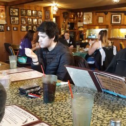 a group of people sitting at a bar a group of people sitting at a bar