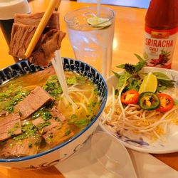 Panda Pho & Boba House - My crane operator lifting 2 slabs of Beef Brisket for this photo!  Brisket Pho, if ya Know, ya know!
