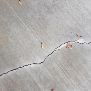 Isborn Concrete - The crack is very deep and flaking off only one (1) month after pour. In addition, there is white streaks form the broom they used - Masonry/Concrete Near Me Isborn Concrete - The crack is very deep and flaking off only one (1) month after pour. In addition, there is white streaks form the broom they used - Masonry/Concrete Near Me