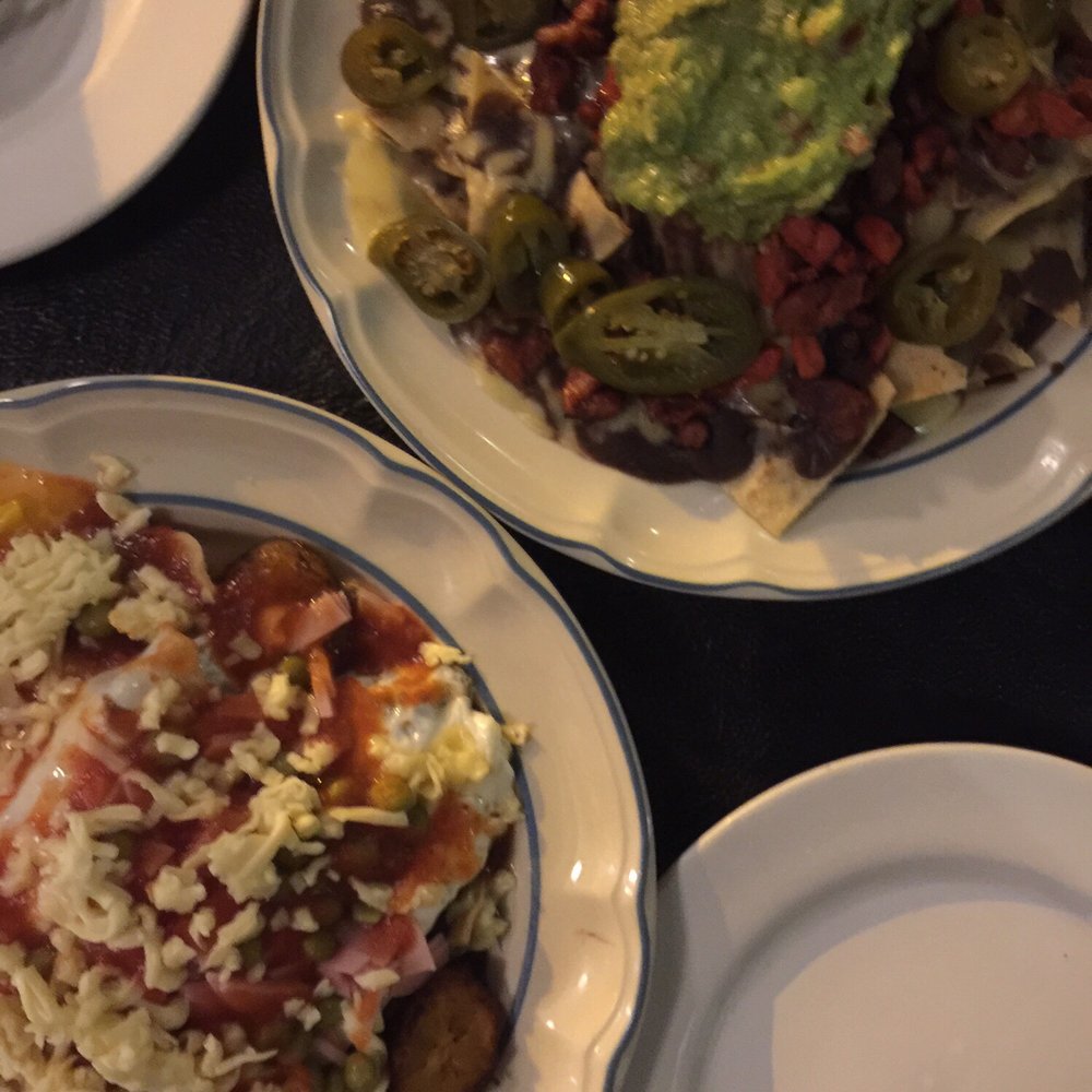 La Calzada - eggs/beans / cheese / ham / fried plantain over a plate of fried chips dish & a classic nacho dish - Mexican Near Me - Valladolid, YUC