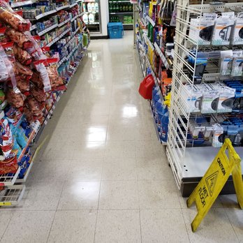 7-Eleven - a grocery store aisle with a caution sign in the foreground - Convenience Stores Near Me - Dorchester, Massachusetts 7-Eleven - a grocery store aisle with a caution sign in the foreground - Convenience Stores Near Me - Dorchester, Massachusetts