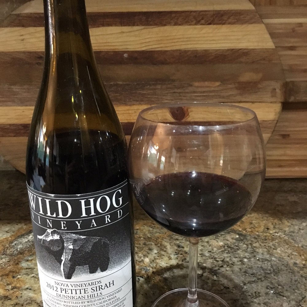 Wild Hog Vineyard - a glass of wine next to a bottle of wine - Wineries Near Me - Cazadero, California