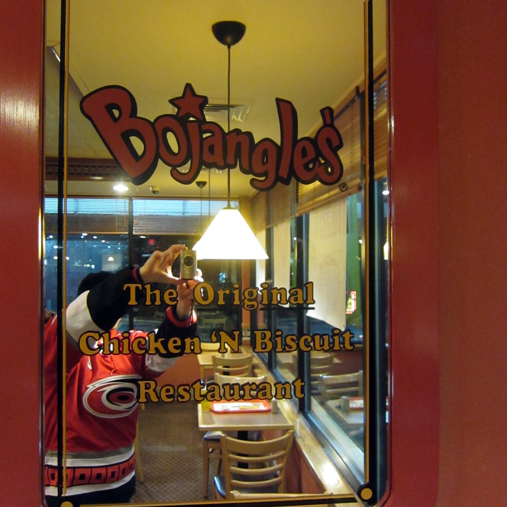 Bojangles - the reflection of a person in a restaurant window - Fast Food Near Me - Raleigh, North Carolina