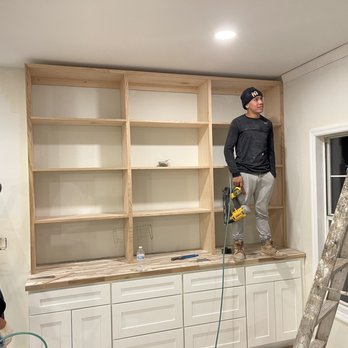 Phoenix Construction & Remodeling - two men working on a built in bookcase - General Contractors Near Me - Lawrenceville, Georgia Phoenix Construction & Remodeling - two men working on a built in bookcase - General Contractors Near Me - Lawrenceville, Georgia