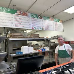 Louie's Pizza - Interior with owner