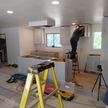 Lawcorp Carpentry - a man standing on a ladder in a kitchen - General Contractors Near Me Lawcorp Carpentry - a man standing on a ladder in a kitchen - General Contractors Near Me