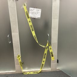 Broken shower made worse by embarrassing signage. Broken shower made worse by embarrassing signage.