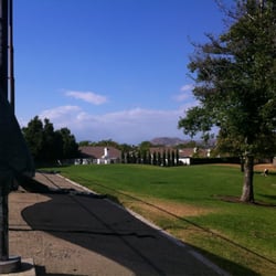 More grass area behind the tennis courts