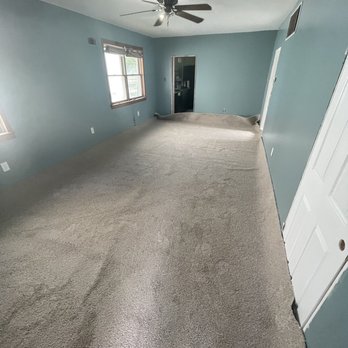 Carpet Palace - a large empty room with a ceiling fan - Carpeting Near Me - Glen Burnie, Maryland