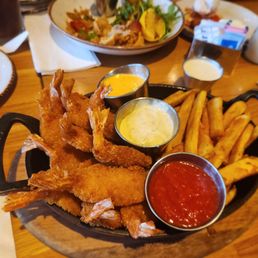 Friend shrimp platter with thick cut fries and various dips, middle one is tartar, the other two I'm not sure. Good dish!
