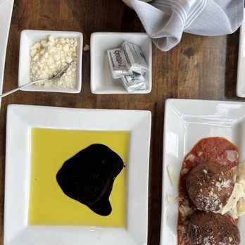 GIO Modern Italian Restaurant - Chesterfield - complimentary bread with unsalted butter, olive oil & balsamic & parmesan bottom right: Arancini (happy hour portion = 2) - Italian Near Me - Chesterfield, Missouri GIO Modern Italian Restaurant - Chesterfield - complimentary bread with unsalted butter, olive oil & balsamic & parmesan bottom right: Arancini (happy hour portion = 2) - Italian Near Me - Chesterfield, Missouri