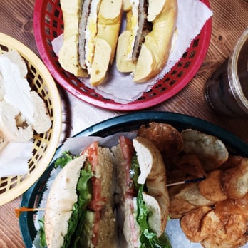 Surf Bagel - Sausage egg, cream cheese on plain, house hummus on Old Bay bagel with lettuce, tomato and pickles with house chips and iced coffee. - Breakfast & Brunch Near Me - Lewes, Delaware