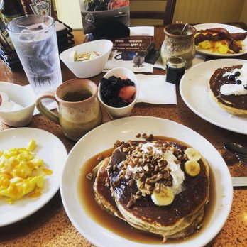 Another Broken Egg Cafe - Bananas Foster Gluten-Free Jumbo Pancakes with a side of eggs and fresh fruit. - Breakfast & Brunch Near Me - Mountain Brook, Alabama