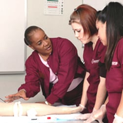 Cambridge Junior Collage - Cambridge Junior College instructor and Medical Assistant students getting hands-on experience. They are learning injections.