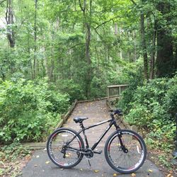 Doko Meadows Park - My bike in front of a wooden bridge that goes through doko meadows