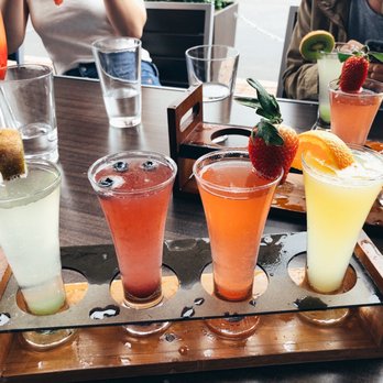 Hash Kitchen - Mimosa Flight. In the background is the Mega Mimosa! - Breakfast & Brunch Near Me - Scottsdale, Arizona