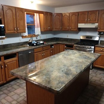 Construction Artisan Enterprises - a kitchen with granite counter tops - General Contractors Near Me