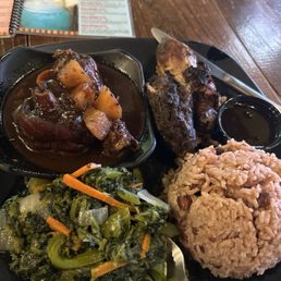 Two meats jerk Anna chicken brown gravy with rice and peas and spinach Two meats jerk Anna chicken brown gravy with rice and peas and spinach