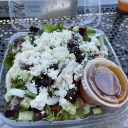 Terra House - Greek Salad~ Fresh Greens, Delicious Dressing (on side), Feta cheese, diced Cucumbers, sliced white onion, kalmata olives & light tomatoes