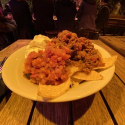 Highbury Vaults - Bowl of nachos showing meat, salsa, sour cream, and chips.