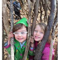 Little School On the Hill - Two preschool students playing and learning in the wooded area behind our school.