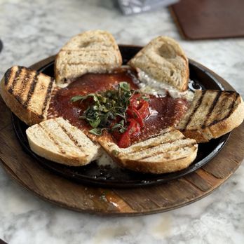 Traveler's Table - Argentinian provoleta - Tapas/Small Plates Near Me - Houston, Texas