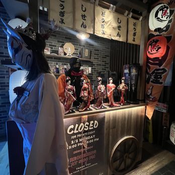 Izakaya Nana - Near the front entry - storefront with thematic yet scary street vender & cat mask wearing mannequins - Izakaya Near Me - Flushing, New York