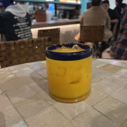 a glass of orange juice on a table