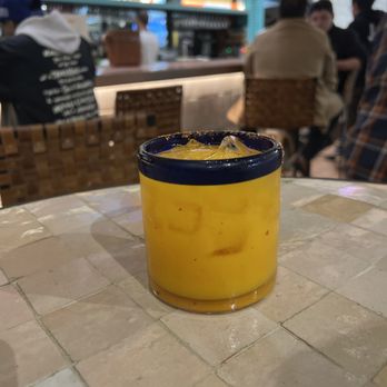 Entre Nos - a glass of orange juice on a table - Mexican Near Me - Costa Mesa, California