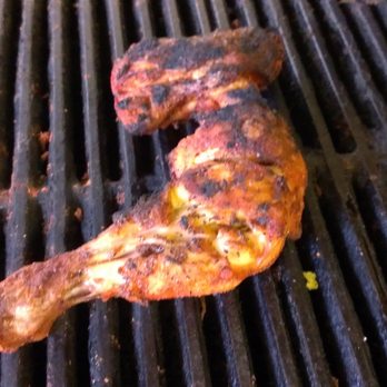 Cafe Habibi - a piece of meat on a grill - Halal Near Me - Houston, Texas