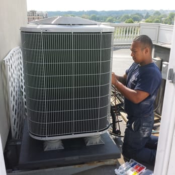 R & B - Tommy installing a new Carrier Comfort Series 14-SEER heat pump, on a rooftop, on a hot day. - Heating & Air Conditioning/HVAC Near Me - Alexandria, Virginia