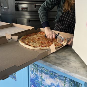 La Pizzetta - Cutting of our pie. Pineapple and ham! - Pizza Near Me - Mt Lebanon, Pennsylvania
