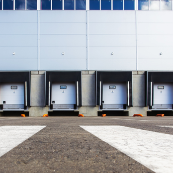 Upstate Door Company - a row of doors in front of a building - Garage Door Services Near Me - Greenville, South Carolina Upstate Door Company - a row of doors in front of a building - Garage Door Services Near Me - Greenville, South Carolina