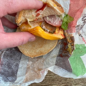 Burger King - a hand holding a half eaten sandwich - Burgers Near Me - Midway Park, North Carolina Burger King - a hand holding a half eaten sandwich - Burgers Near Me - Midway Park, North Carolina