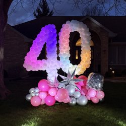 Pop of Color - Light up yard art - balloon number display! Color chasing lights and uplights.