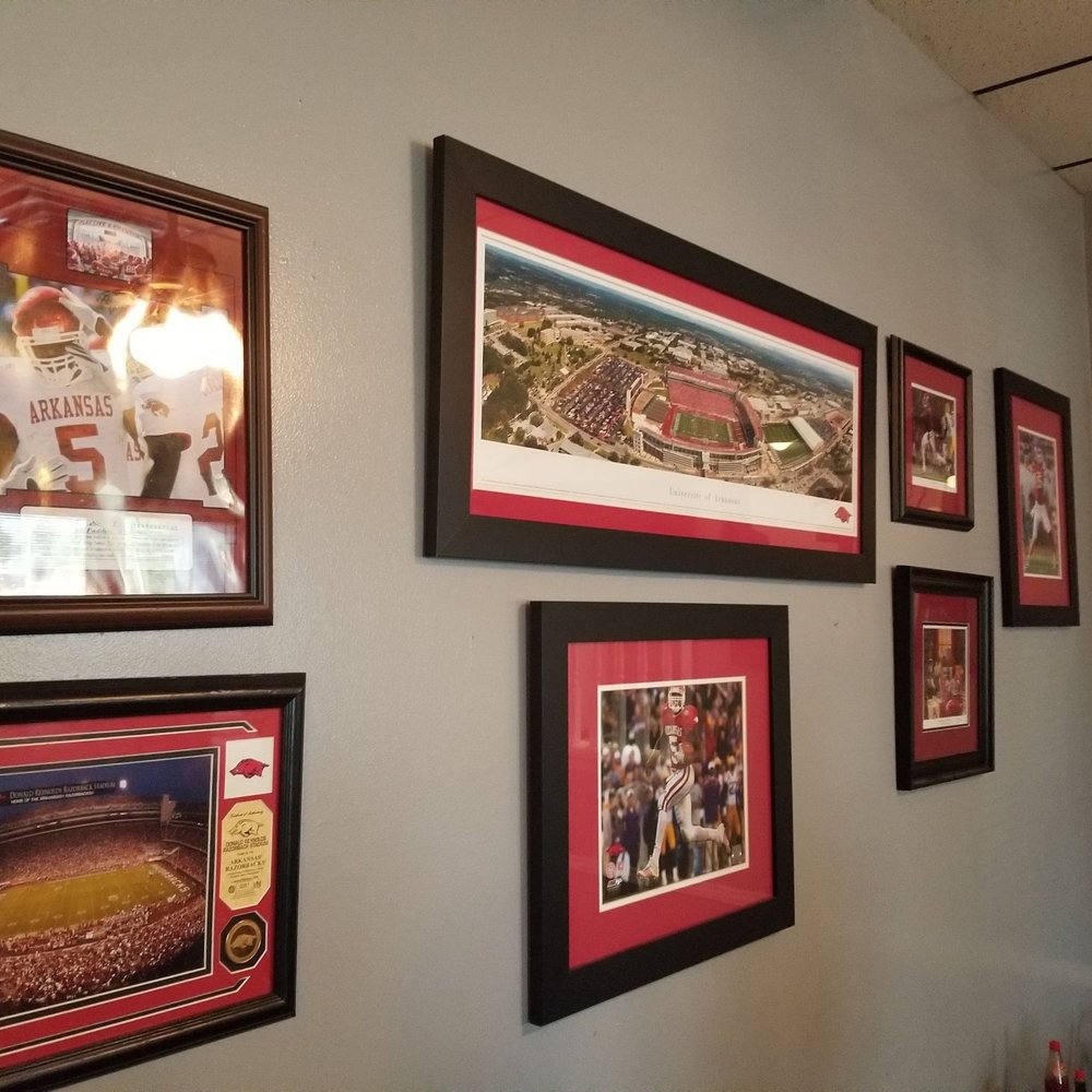 Leon's Catfish & Shrimp Restaurant - a wall of framed sports memorabilia - Seafood Near Me - Pine Bluff, Arkansas
