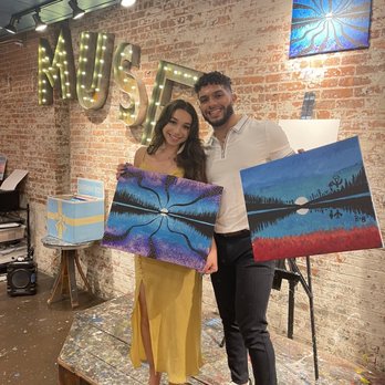 Muse Paintbar - Tribeca - Instructor stand and our paintings - Paint & Sip Near Me - New York, New York Muse Paintbar - Tribeca - Instructor stand and our paintings - Paint & Sip Near Me - New York, New York