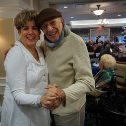 Jewish Home Assisted Living - A JHAL Resident dances with his daughter.