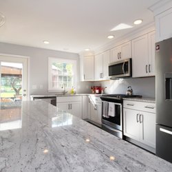 Creative Remodeling Services - Strykersville Kitchen Renovation- White Shaker Cabinetry Featuring Large Island with Seating and Granite Countertops.