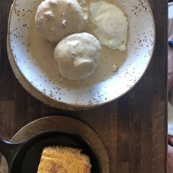 J. Wilson's - Biscuits and Gravy with a fried egg and side of cheesy grits - New American Near Me - Beaumont, Texas