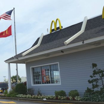 McDonald's - an american flag flying in the wind - Fast Food Near Me - Massapequa, New York McDonald's - an american flag flying in the wind - Fast Food Near Me - Massapequa, New York