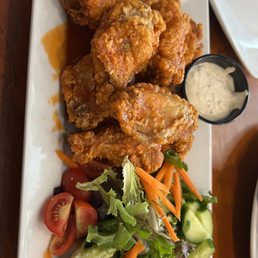 a plate of fried chicken and salad