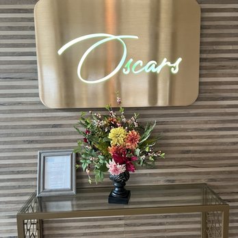 Oscar's Oceanside - a vase of flowers on a table - Seafood Near Me - Virginia Beach, Virginia