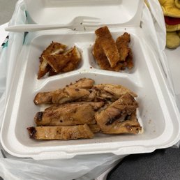 a takeout box with a variety of food items a takeout box with a variety of food items