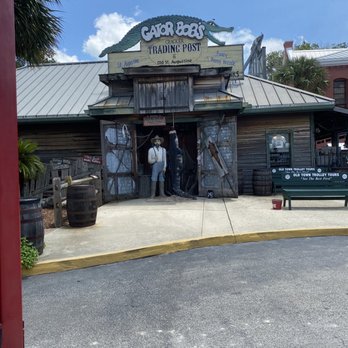Red Train Tours - A wooden building features a sign for Gator Bait and a crocodile figure on top, with a mannequin dressed as a cowboy in front. - Tours Near Me - Saint Augustine, Florida