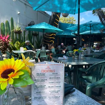 Old Town Mexican Cafe - a table with a menu and a sunflower - Mexican Near Me - Key West, Florida