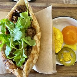 KooLuLu - Short Rib: Overnight short rib, tahini, chimichurri, lemon cream, grilled onion, tomato and confit garlic.